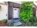 Charming front entrance with a brick facade and screened-in porch at 9130 Dresden Ln, Port Richey, FL 34668