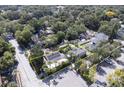Aerial view showcasing the property with a fenced yard, solar panels, and mature trees at 921 24Th N Ave, St Petersburg, FL 33704