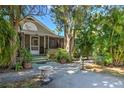 Charming home with lush landscaping, a screened porch, and a inviting entryway at 921 24Th N Ave, St Petersburg, FL 33704