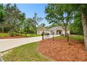 Beautiful single Gathering home with mature trees, well-manicured lawn, and long driveway at 9801 Pine Leaf Ln, Dade City, FL 33525
