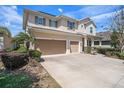 Charming two-story home featuring a well-manicured lawn, stone accents, and a convenient two-car garage at 1018 Tracey Ann Loop, Seffner, FL 33584