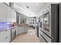 Beautiful bright kitchen with white cabinets, stainless steel appliances, and barstool seating at 10602 Rochester Way, Tampa, FL 33626