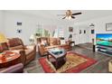 Inviting living room showcasing a comfortable leather sofa, plantation shutters, and contemporary decor at 11777 90Th Ave, Seminole, FL 33772