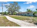 Attractive single-story home with a well-kept front yard and a long sidewalk at 1216 E Lemon St, Tarpon Springs, FL 34689