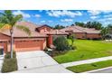 Inviting single-story home with a tile roof, lush lawn, and well-kept landscaping at 146 Shell Falls Dr, Apollo Beach, FL 33572