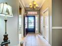 Bright foyer with neutral walls, chandelier, and view to the outside at 146 Shell Falls Dr, Apollo Beach, FL 33572