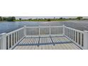 Lake view from a wooden back porch with white rails at 1806 Wolf Laurel Dr, Sun City Center, FL 33573