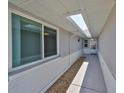 Exterior walkway of the home, featuring a skylight and neutral color scheme at 1806 Wolf Laurel Dr, Sun City Center, FL 33573