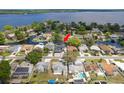 Expansive aerial view showcasing the waterfront property, private boat dock, and serene neighborhood atmosphere at 182 E Canal Dr, Palm Harbor, FL 34684
