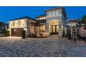 Two-story home with a gray exterior, double doors, and a brick driveway and boat parked out front at 182 E Canal Dr, Palm Harbor, FL 34684