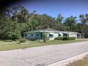 Charming single-story home with a well-maintained lawn and mature trees in a desirable neighborhood at 2001 E Powhatan Ave, Tampa, FL 33610