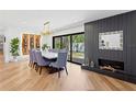 Elegant dining room featuring a modern fireplace, sleek wood floors, and a wine rack at 207 S Coolidge Ave, Tampa, FL 33609