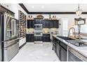 Gourmet kitchen boasts stainless steel appliances, marble floors, and a stylish wine rack at 2332 Dekan Ln, Land O Lakes, FL 34639