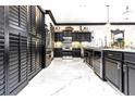 Elegant kitchen featuring sleek black cabinets, marble floors, and modern stainless steel appliances at 2332 Dekan Ln, Land O Lakes, FL 34639