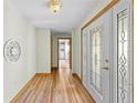Inviting entryway featuring wood-look floors and a decorative front door with leaded glass at 24076 Ragan Dr, Brooksville, FL 34601
