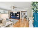 Cozy living room featuring hardwood floors, paneled walls, and abundant natural light at 2815 W Estrella St, Tampa, FL 33629