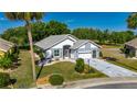 Beautiful single-story home showcasing a well-manicured lawn, two-car garage, and charming curb appeal at 334 Northway Dr, Sun City Center, FL 33573