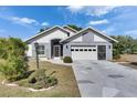 Charming single-story home featuring a two-car garage, beautiful landscaping, and a welcoming entryway at 334 Northway Dr, Sun City Center, FL 33573