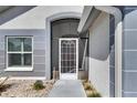 Close-up of the front door featuring a decorative glass insert and neutral paint scheme at 334 Northway Dr, Sun City Center, FL 33573