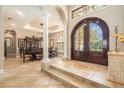 Grand foyer with tile flooring, columns, and an ornate front door at 3607 Berger Rd, Lutz, FL 33548