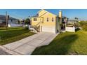 Two-story home features a spacious driveway, well-maintained lawn, and a boat on the side at 4116 Diaz Ct, Hernando Beach, FL 34607