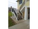 Exterior stairs show a house that may need some updates to the stair finish and the exterior paint at 4116 Diaz Ct, Hernando Beach, FL 34607