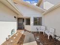 Inviting entrance with white Adirondack chairs and a charming walkway to the front door at 456 Lakeview Dr # 5, Palm Harbor, FL 34683