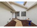 Inviting front entrance with a white front door, two windows, and tasteful landscaping at 456 Lakeview Dr # 5, Palm Harbor, FL 34683