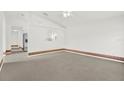 Bright living room with vaulted ceiling, neutral carpet, and archway to adjacent rooms at 5400 9Th N Ave, St Petersburg, FL 33710