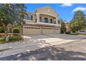 Home exterior featuring a stone-clad facade, balcony, three garages, and a wide concrete driveway at 5717 Kingletsound Pl, Lithia, FL 33547