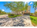 Attractive condo exterior with a covered parking area, lush landscaping, and well-maintained curb appeal at 6 Academy S Way # 23A, St Petersburg, FL 33711