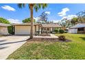 Charming single-story home boasts a well-manicured lawn, mature landscaping, and a two-car garage at 6330 Quail Ridge Dr, Tampa, FL 33625