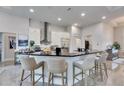 Modern kitchen featuring a large island with seating, stainless steel appliances, and stylish backsplash at 706 Manns Harbor Dr, Apollo Beach, FL 33572