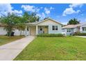 A charming one-story home with a well-manicured lawn, a one-car garage, and a lovely front porch at 7113 S Mascotte St, Tampa, FL 33616