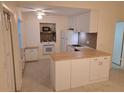 Bright kitchen featuring white cabinetry, butcher block countertops, and modern appliances at 754 71St N Ave, St Petersburg, FL 33702