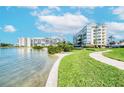 Beautiful waterfront condo buildings surrounded by lush landscaping and a curving sidewalk at 7872 Sailboat Key S Blvd # 404, South Pasadena, FL 33707