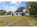Charming single-story home boasts a modern exterior with a well-maintained front yard at 8512 Longboat Ln, Hudson, FL 34667