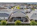 Aerial view of a home with a screened-in pool and patio, surrounded by houses in a suburban neighborhood at 8720 Drummer Plank Dr, Wesley Chapel, FL 33545