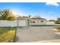 Inviting home featuring a one-car garage and manicured landscaping at 8801 Sunlit Cove Ne Dr, St Petersburg, FL 33702