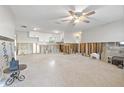 Expansive living room with a ceiling fan, offering a bright and airy space at 8801 Sunlit Cove Ne Dr, St Petersburg, FL 33702
