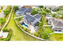A sprawling backyard with a private pool oasis, rock features, and outdoor gazebo for entertaining at 9607 Orange Jasmine Way, Tampa, FL 33647