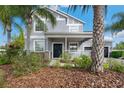 Charming two-story home with a welcoming front porch and well-manicured landscaping at 9607 Orange Jasmine Way, Tampa, FL 33647