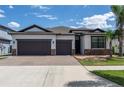 Beautiful two-story home featuring a paved driveway, a two-car garage, and manicured landscaping at 10008 Celtic Ash Dr, Ruskin, FL 33573