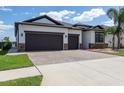 Beautiful home featuring a paved driveway, a two-car garage, and well-maintained landscaping at 10008 Celtic Ash Dr, Ruskin, FL 33573