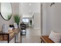 Bright hallway with tile flooring, elegant decor, and a view into a living room overlooking a serene lake at 10008 Celtic Ash Dr, Ruskin, FL 33573