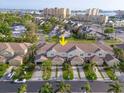 Aerial view of townhomes close to the beach and nearby bay at 11260 Kapok Grand Cir, Madeira Beach, FL 33708