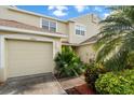 Well-maintained home with a neatly kept lawn and a classic garage door at 11260 Kapok Grand Cir, Madeira Beach, FL 33708