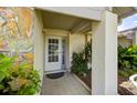 Charming front porch with stone accents, tiled flooring, and lush landscaping at 12024 Stone Crossing Cir, Tampa, FL 33635