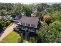 Captivating aerial view of a two-story house surrounded by mature trees at 1226 Serpentine S Dr, St Petersburg, FL 33705