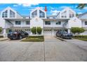 Attractive townhome exterior with a one car garage, manicured landscaping, and a clean driveway at 14649 Seminole Trl # 5, Seminole, FL 33776